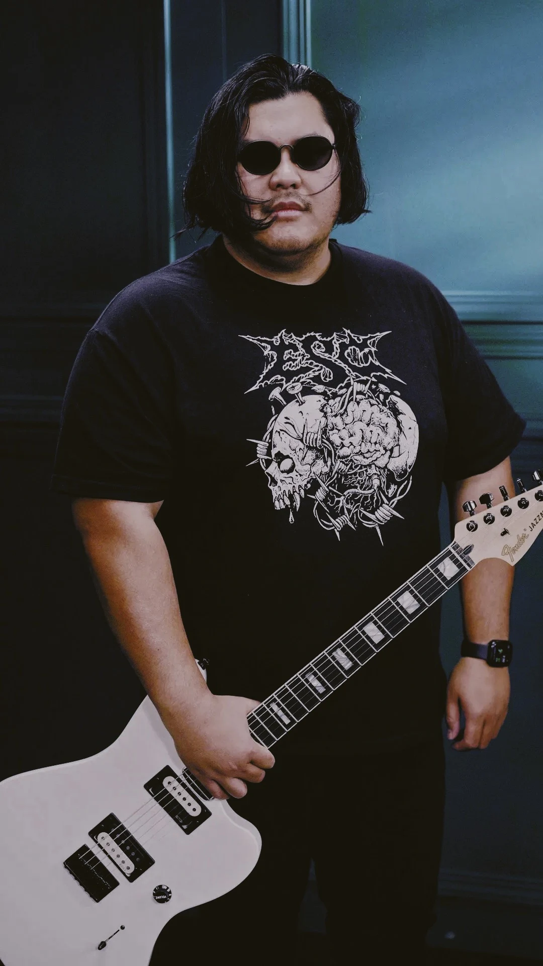 Don holding a white electric guitar